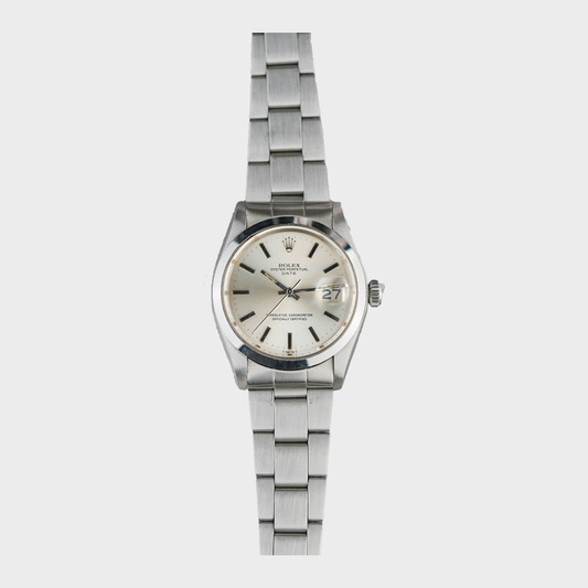 Silver wristwatch with a detailed face on a white background